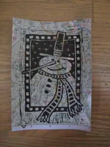 snowman lino cut printed on map