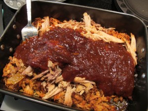 shredded pork mixed with sauce, with extra sauce to mix in