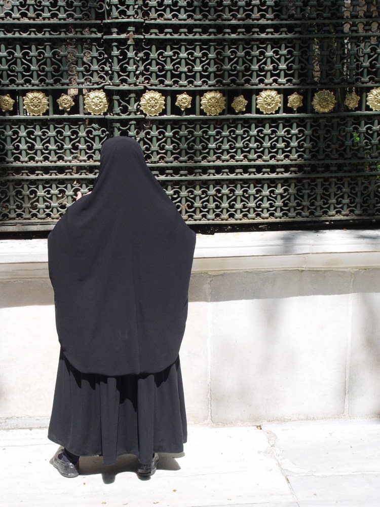 Turkish woman in front of tomb