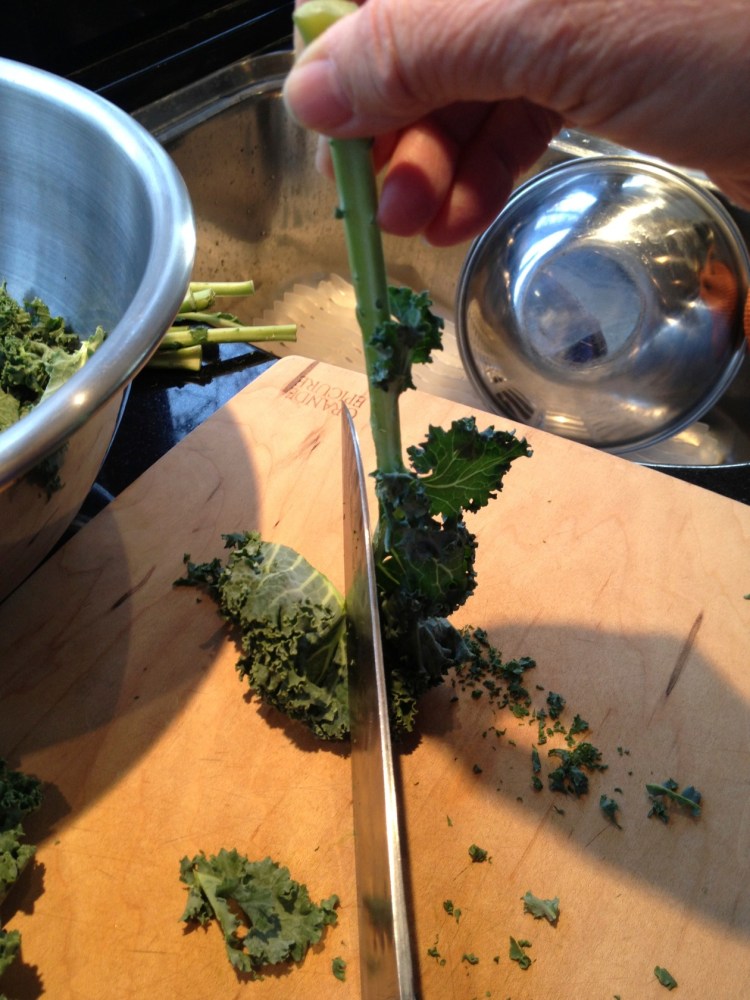 slicing leaves from kale stem