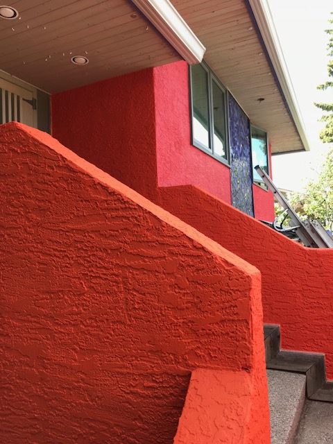 orange and coral stucco with blue tile mosaic